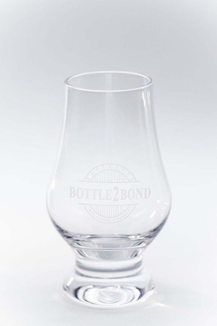 The Bottle2Bond 3 oz hand-blown crystal tasting glass, empty, on a pale background